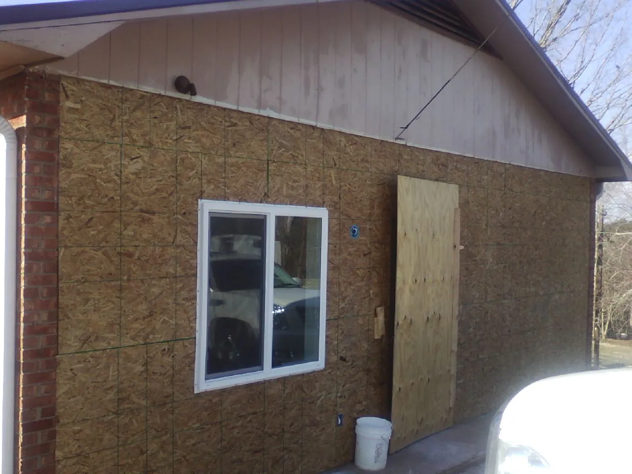 OSB sheathing on a garage addition wall before siding in Ho Ho Kus